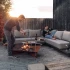 Höfats TRIPLE 120 Bålfad i Corten stål med brændende træstammer, placeret på en hvid overflade. Bålfadet har et moderne design o